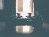 A game controller silhouetted on a table in a dim room