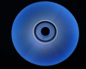 An optical disc glowing blue against a black background