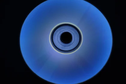 An optical disc glowing blue against a black background