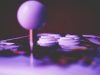 An arcade joystick and buttons lit in purple