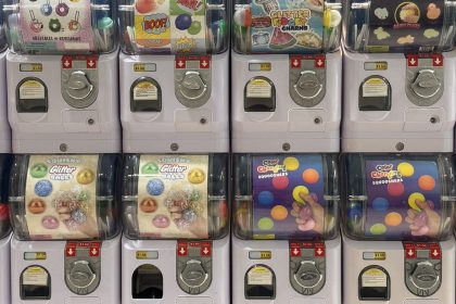 Rows of capsule toy vending machines with colorful prize displays