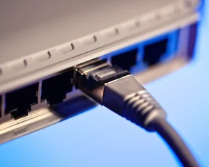 An Ethernet cable plugged into a port on the back of a router