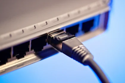 An Ethernet cable plugged into a port on the back of a router